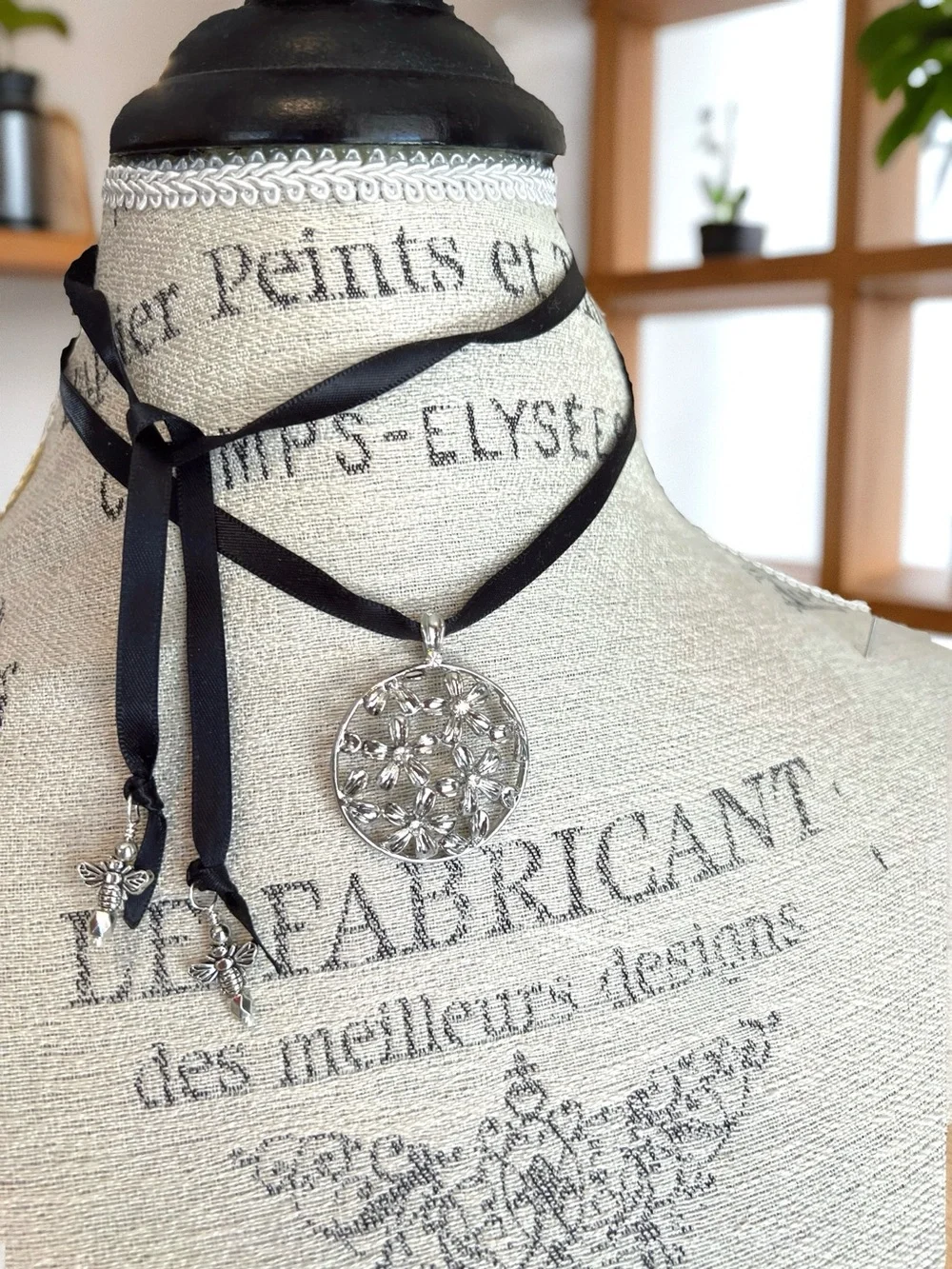 Silver Toned Floral Cutout Pendant Necklace on Black Satin Ribbon